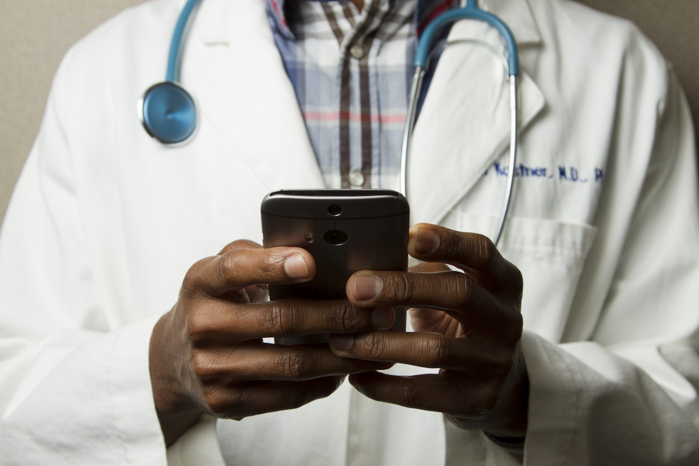 A doctor using a phone — your care team, one tap away